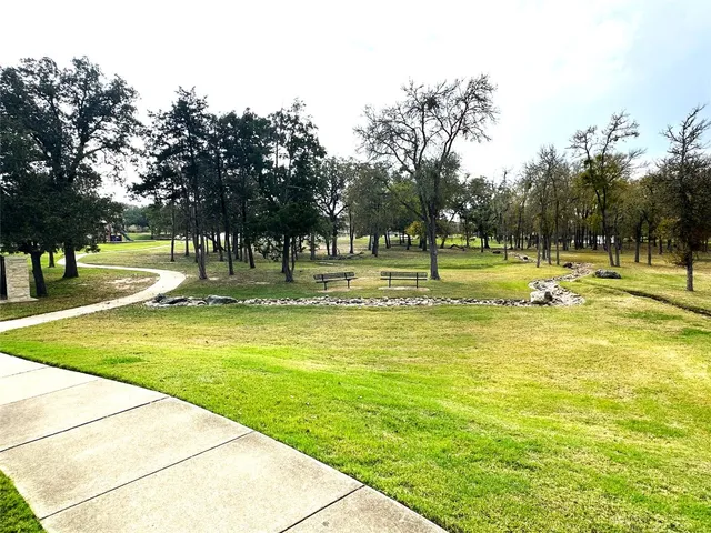 a swimming pool with outdoor seating and yard
