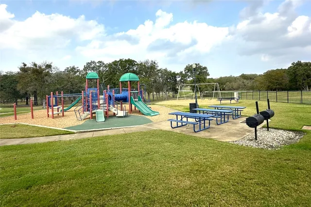 a view of a swimming pool with a patio and a yard