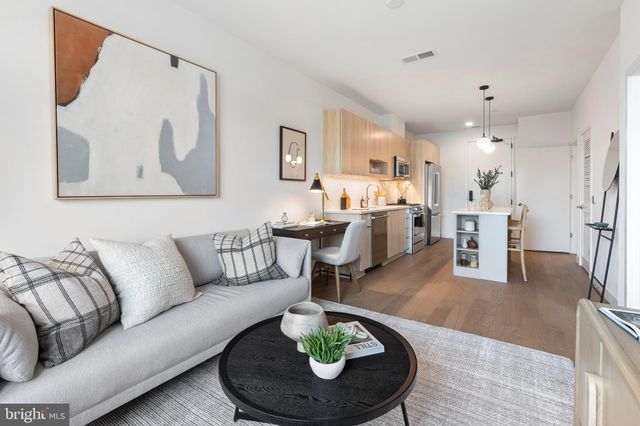 a living room with furniture and a dining table