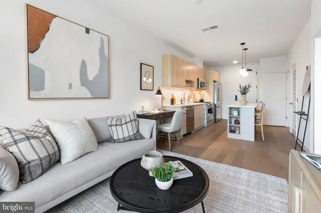 a living room with furniture and a dining table