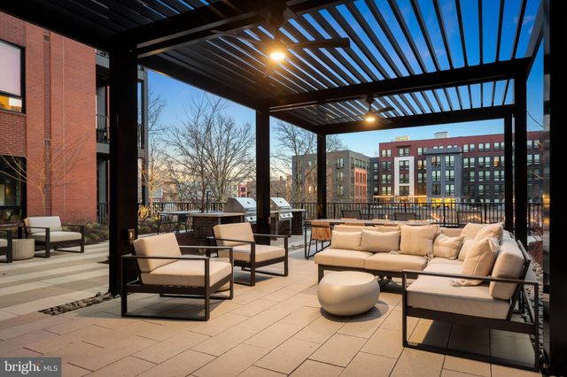 a building outdoor space with patio furniture and potted plants