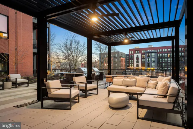 a building outdoor space with patio furniture and potted plants