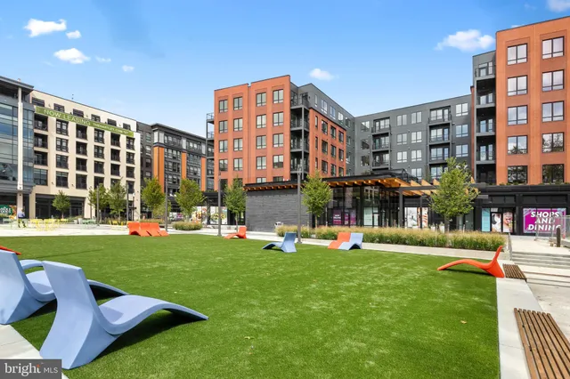 a front view of building with yard and outdoor seating