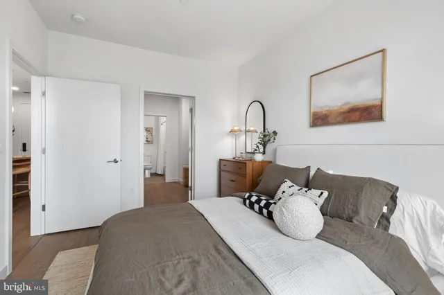 a living room with furniture and a painting on the wall
