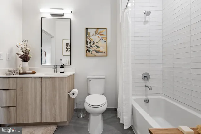 a bathroom with a toilet a sink and bathtub