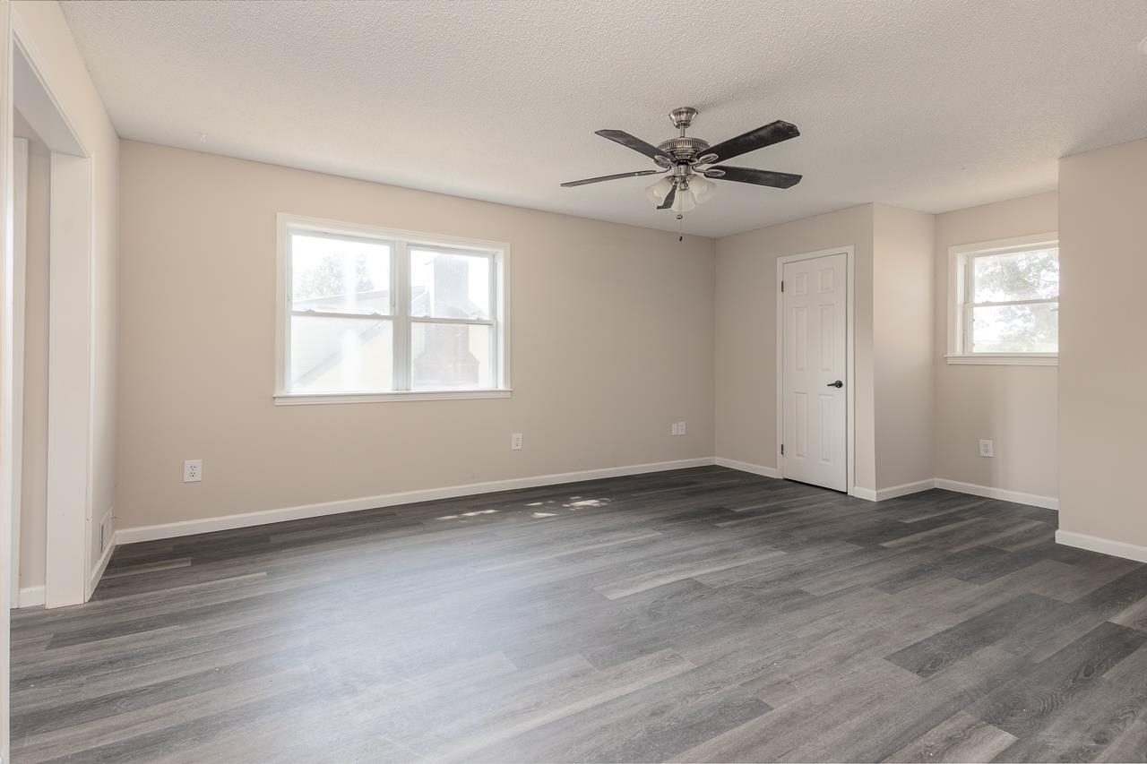 2718 Kate Bond Road Memphis, TN 38133 - Photo 22 of 39 Unfurnished room with dark wood-style flooring, a ceiling fan, and a textured ceiling