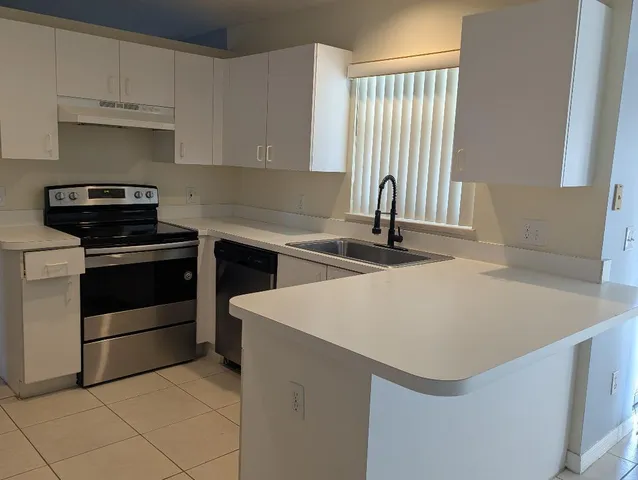 a kitchen with a sink and a stove