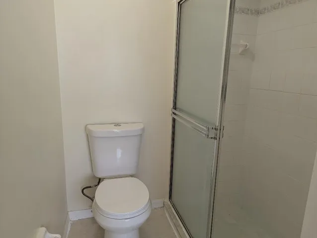 a white toilet sitting in a bathroom