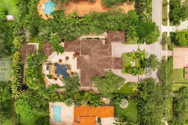 an aerial view of a house with a yard