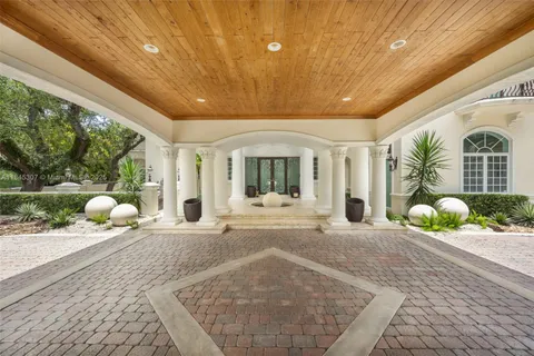 a spacious bedroom with a bed a couch and dresser