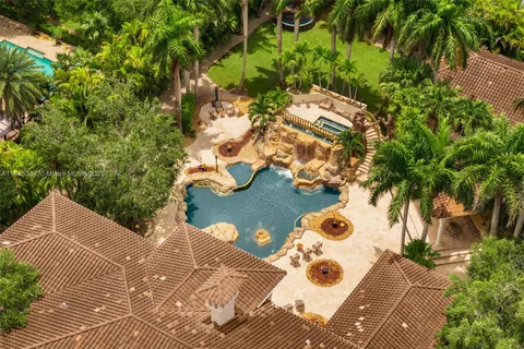 an aerial view of a house with a yard