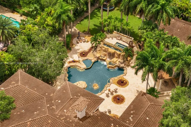 an aerial view of a house with a yard