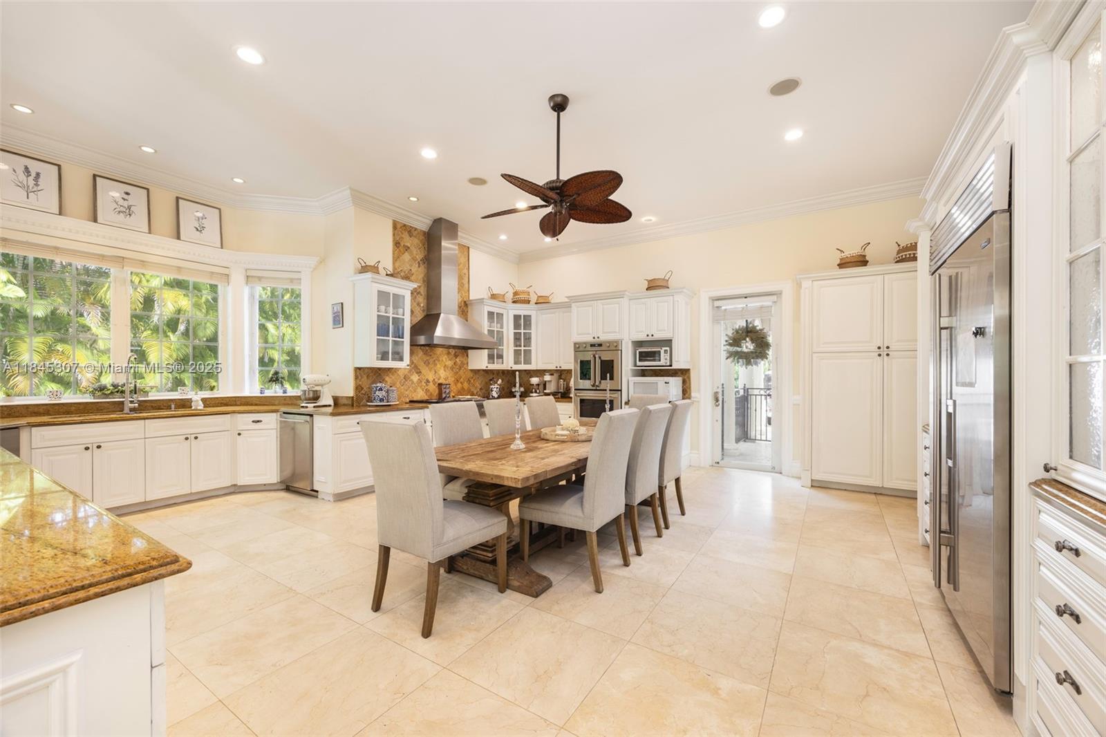 0 7245 Southwest 104th Street Pinecrest, FL 33156 - Photo 33 of 74 a dining room with stainless steel appliances kitchen island granite countertop furniture and a large window