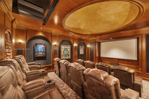 a view of a white house in a big yard with large trees and plants