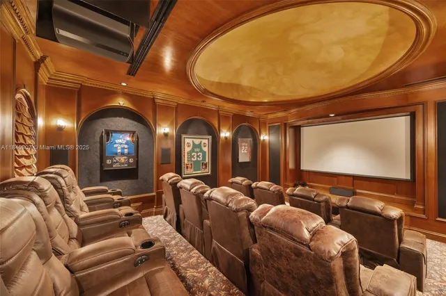 a view of a white house in a big yard with large trees and plants