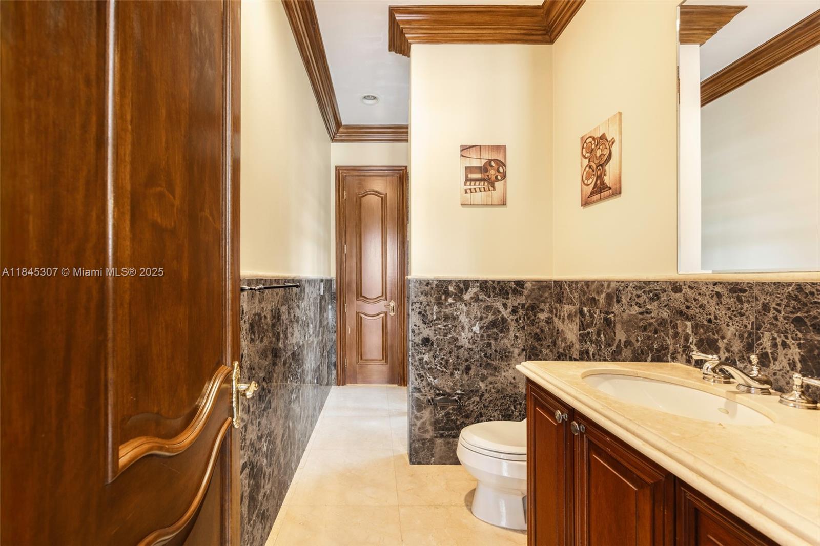 0 7245 Southwest 104th Street Pinecrest, FL 33156 - Photo 54 of 74 a bathroom with a sink a toilet a mirror and shower