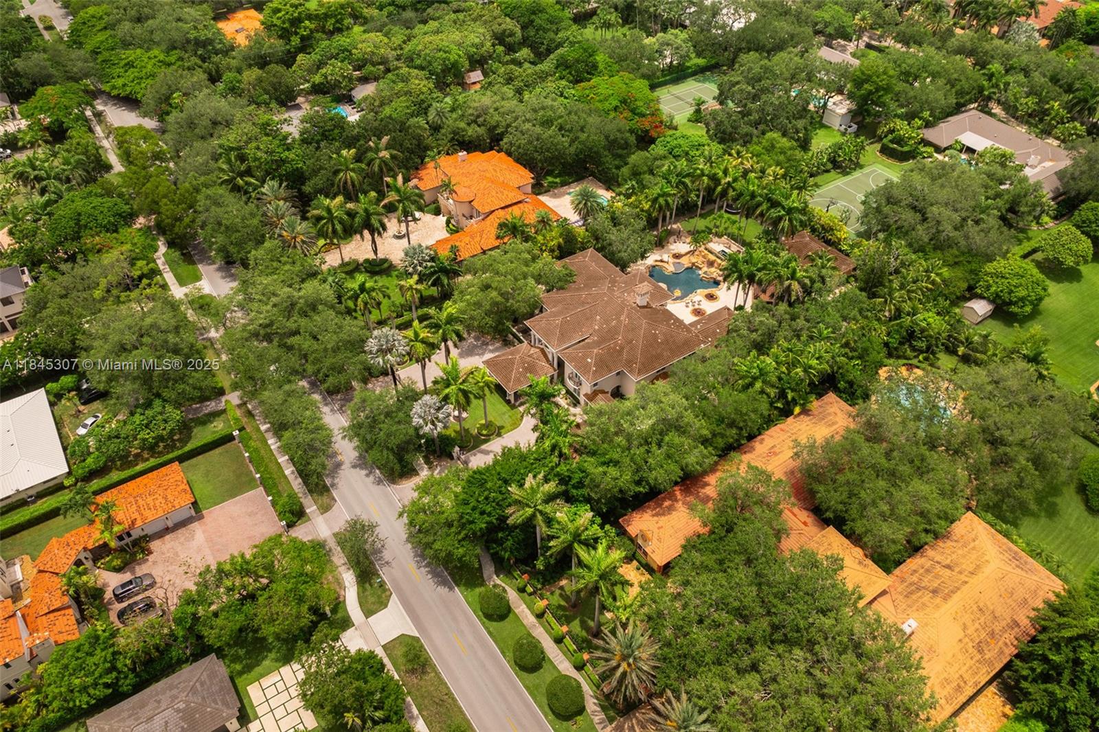 0 7245 Southwest 104th Street Pinecrest, FL 33156 - Photo 6 of 74 an aerial view of a house with a yard and swimming pool