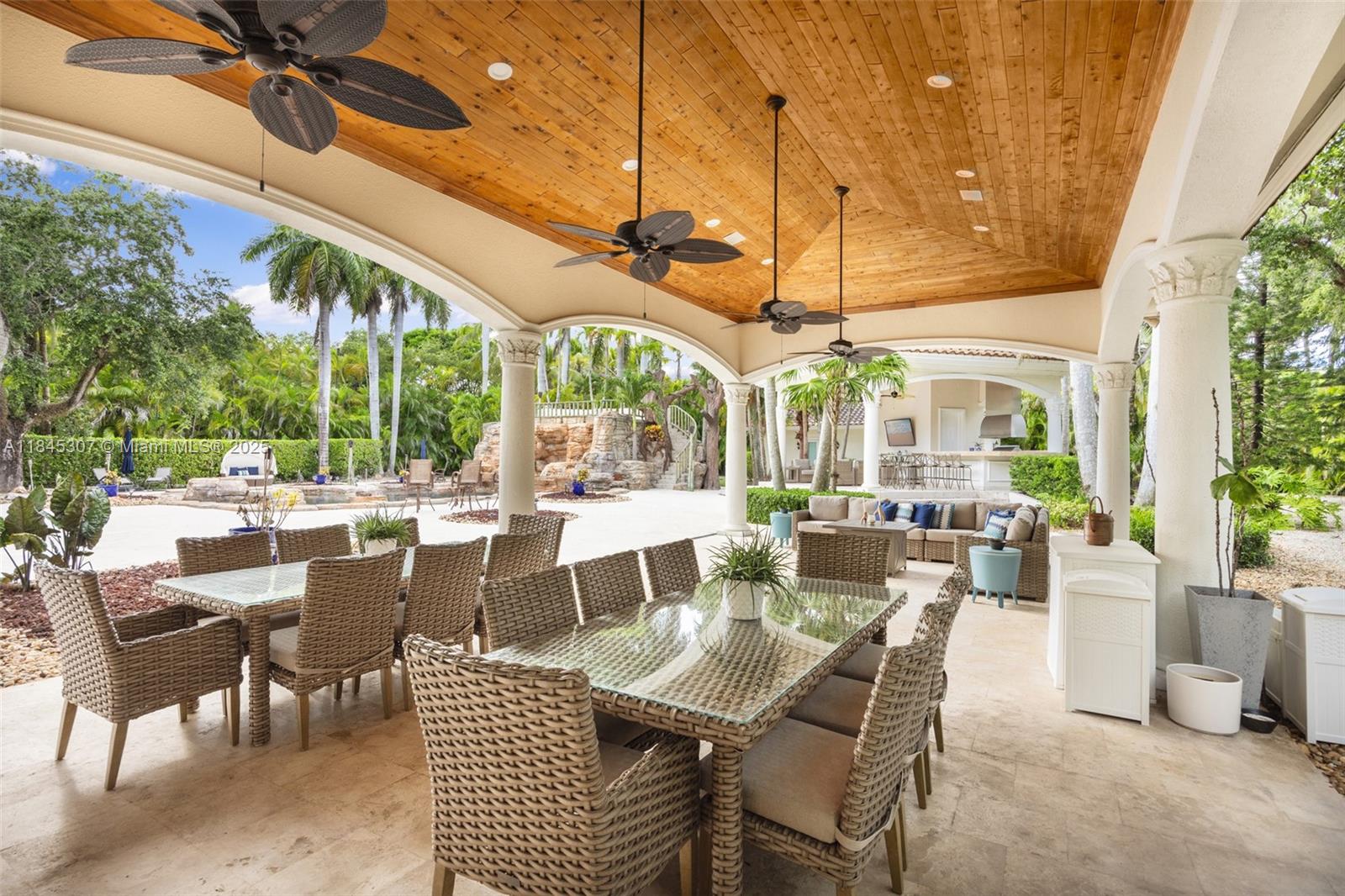 0 7245 Southwest 104th Street Pinecrest, FL 33156 - Photo 65 of 74 a view of a dining room with furniture wooden floor and chandelier