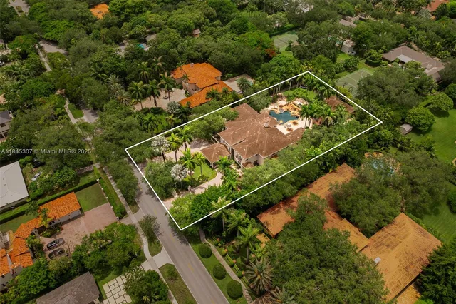 a front view of a house with a yard and potted plants