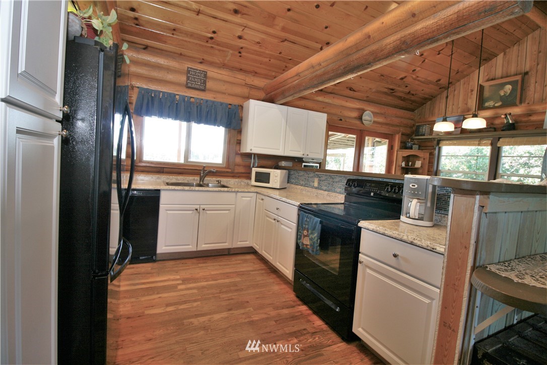 1304 Radio Road Ellensburg, WA 98926 - Photo 5 of 26 a kitchen with a sink window and stainless steel appliances