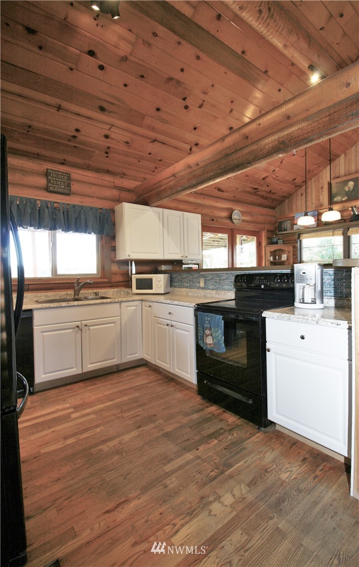 1304 Radio Road Ellensburg, WA 98926 - Photo 6 of 26 a kitchen with a stove sink and cabinets