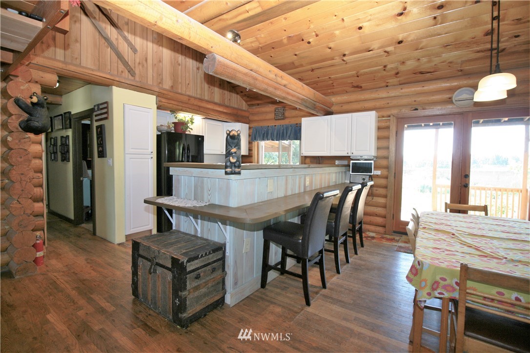 1304 Radio Road Ellensburg, WA 98926 - Photo 8 of 26 a dining room with furniture a kitchen wooden floor and a front door