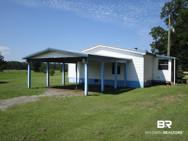 20705 Greek Cemetery Road Robertsdale, AL 36567 - Photo 1 of 25 Back of property featuring a lawn and driveway