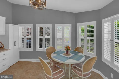 a view of a dining room with a table and chairs