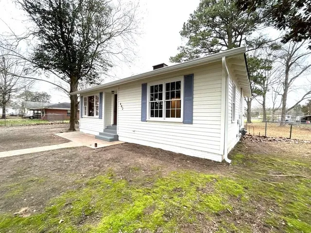 a backyard of a house with table and chairs