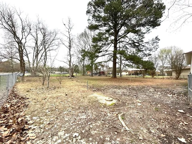 a view of yard covered with snow in front of house