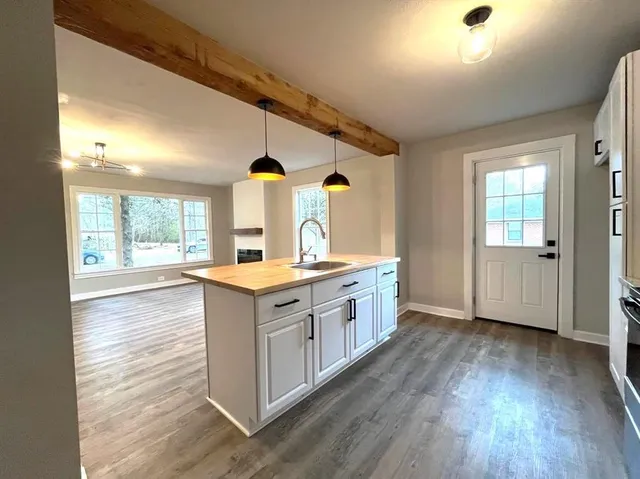 wooden floor in an empty room with a window and wooden floor