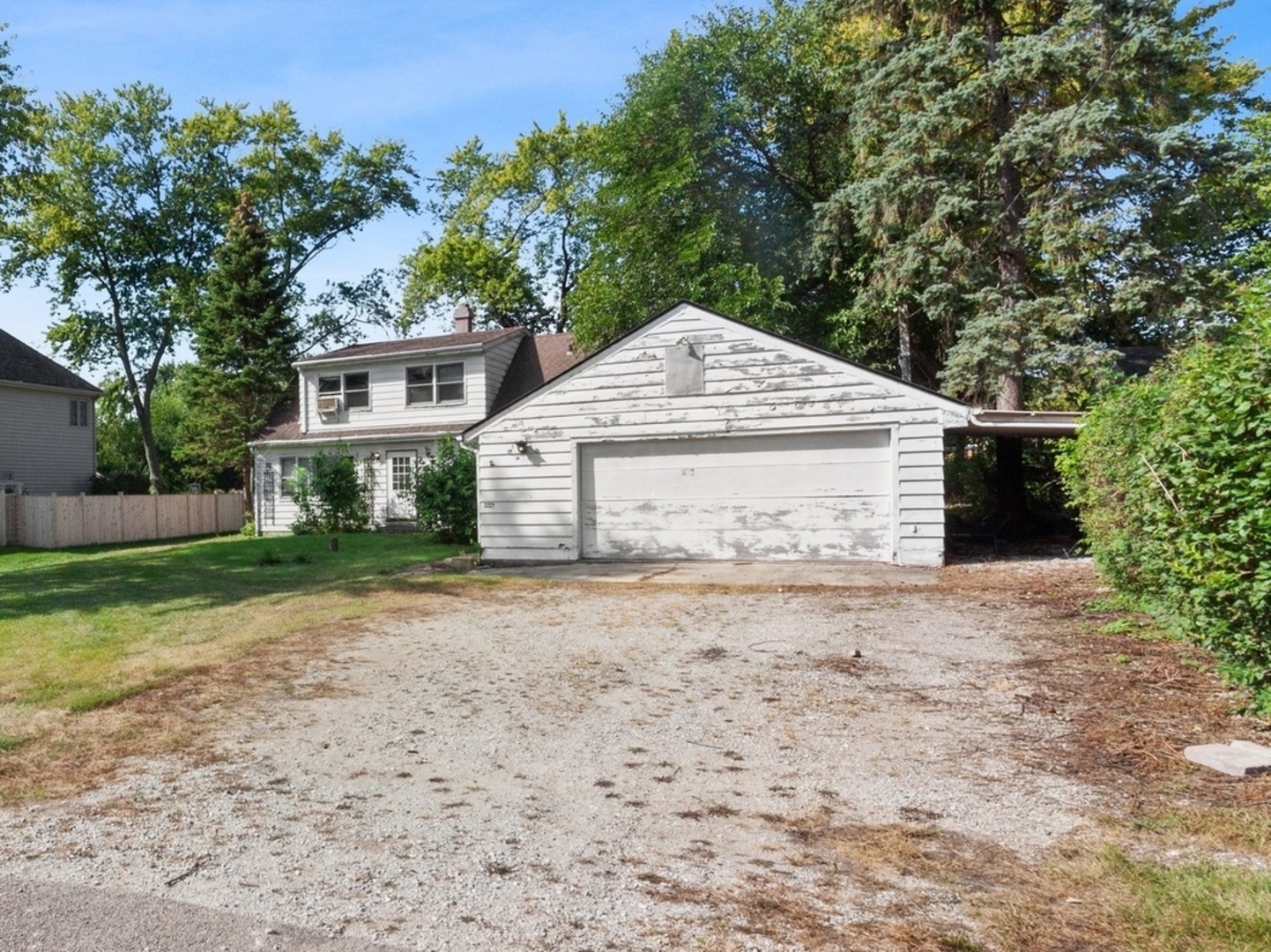 5S578 Tuthill Road Naperville, IL 60563 - Photo 3 of 23 a front view of a house with a garden and trees