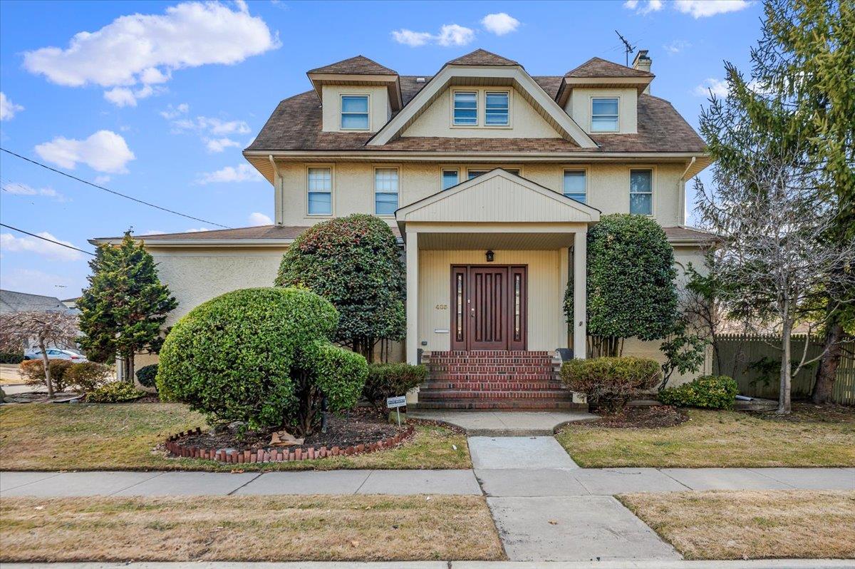 View of front of property with fence and stucco siding