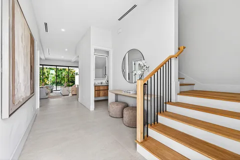 a view of an entryway with wooden floor and door