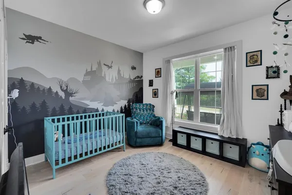 a bedroom with furniture and a window