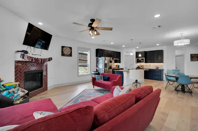 a living room with furniture a flat screen tv and a fireplace