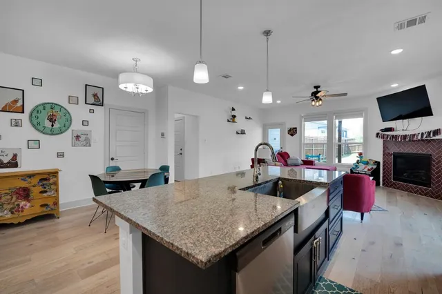 a living room with furniture a flat screen tv and a table