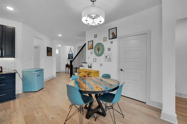 a view of a dining room with furniture and chandelier