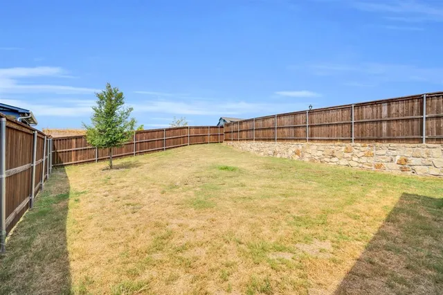 a view of a house with wooden floor and fence