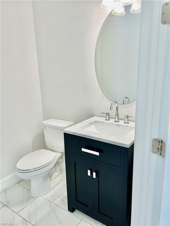 7841 Bristol Circle Naples, FL 34120 - Photo 10 of 31 Bathroom with vanity and light marble finish flooring