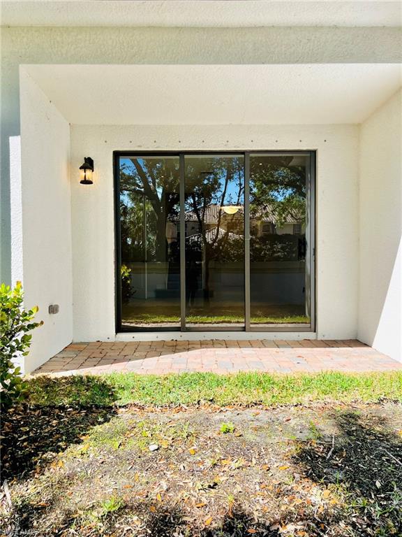 7841 Bristol Circle Naples, FL 34120 - Photo 12 of 31 Doorway to property with a patio area