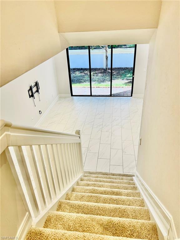 7841 Bristol Circle Naples, FL 34120 - Photo 13 of 31 Staircase with baseboards