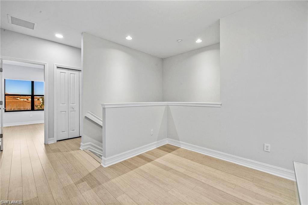 7841 Bristol Circle Naples, FL 34120 - Photo 19 of 31 Spare room with recessed lighting and light wood-style flooring