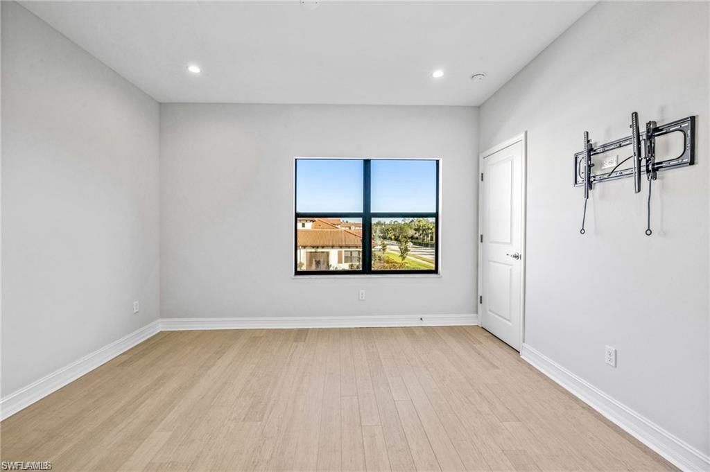7841 Bristol Circle Naples, FL 34120 - Photo 22 of 31 Unfurnished room with light wood-style floors and recessed lighting