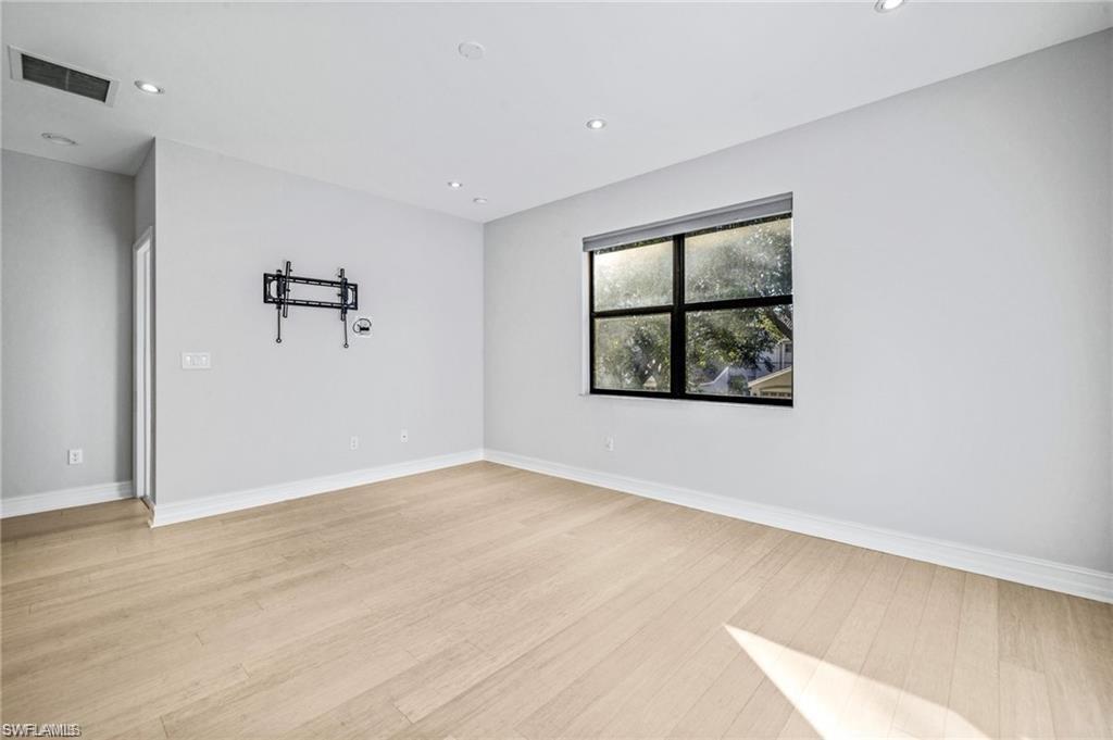 7841 Bristol Circle Naples, FL 34120 - Photo 24 of 31 Empty room featuring recessed lighting and light wood-type flooring