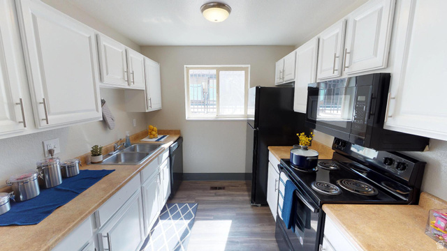 1960 North Canyon Road Provo, UT 84604 - Photo 5 of 6 Kitchen featuring black appliances, white cabinets, light countertops, and dark wood-type flooring