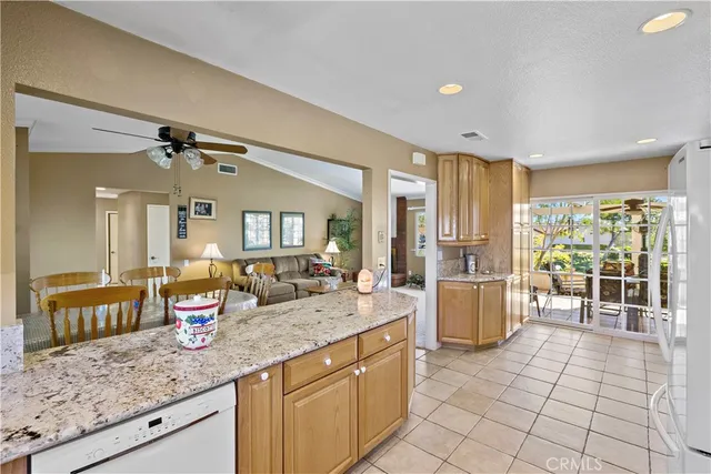 a kitchen with a refrigerator a stove a sink and cabinets