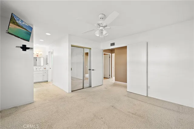 a bathroom with a sink a toilet and shower a mirror