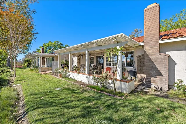 a view of a house with backyard porch and sitting area