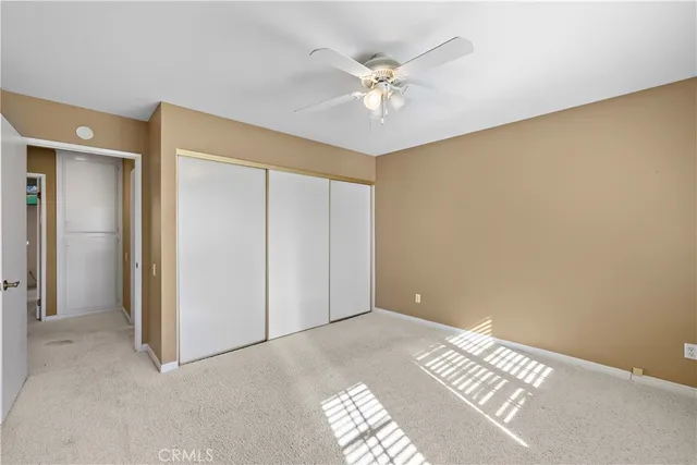 a view of a patio with table and chairs potted plants and floor to ceiling window